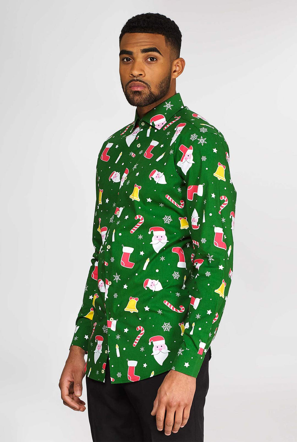Man wearing green Christmas dress shirt with colored Christmas icons