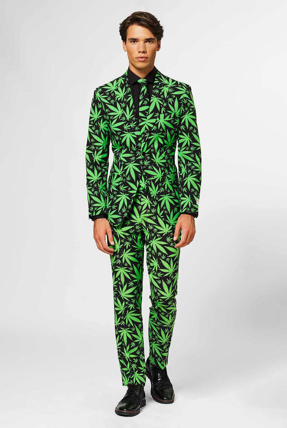Man wearing black men's suit with green cannabis print