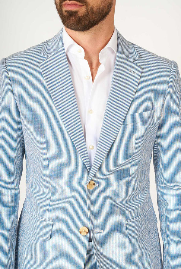 Man wearing stripped blue and white seer sucker suit