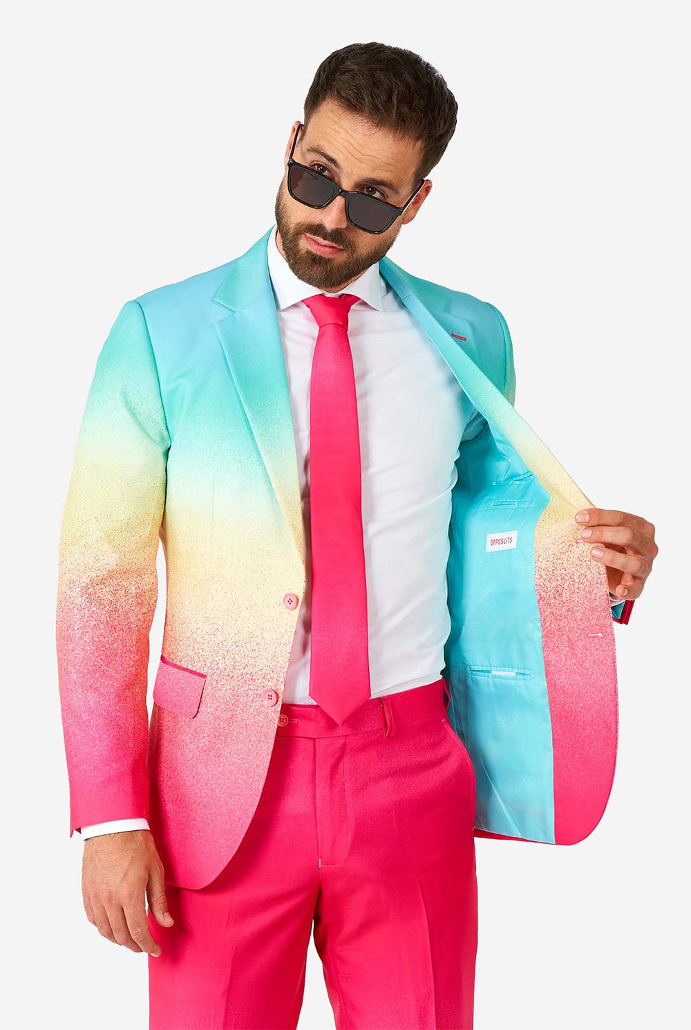 Video of man wearing Funky Fade pride men's suit, showing suit like a model. Suit consists of blazer, pant and tie.