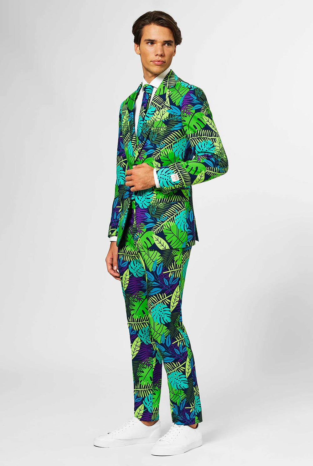 Jungle print men's suit with green and purple leaf print worn by man