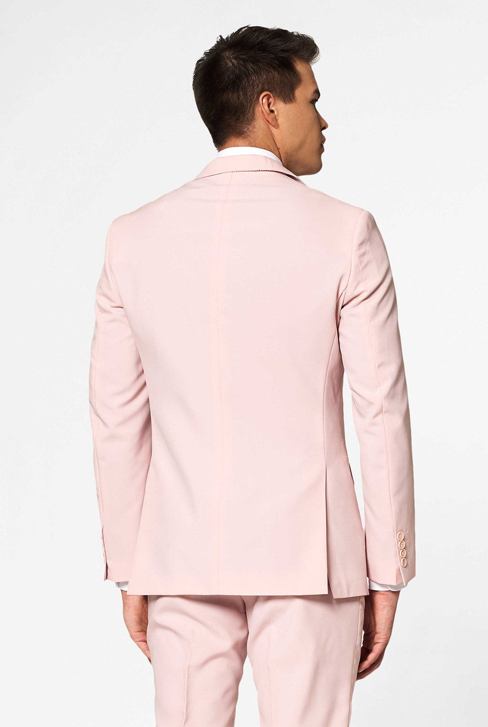Video of man wearing Lush Bush, soft pink men's suit, showing suit like a model. Suit consists of blazer, pant and tie.