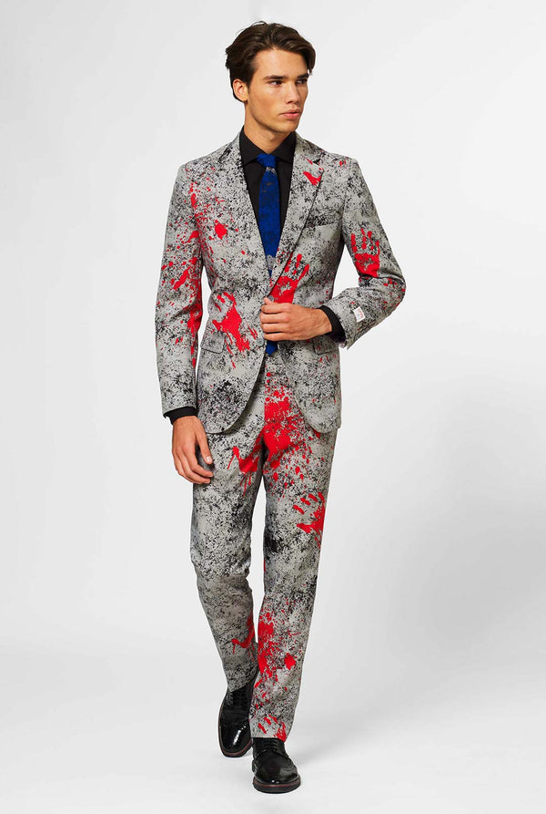 Man wearing grey Halloween men's suit with blood stains