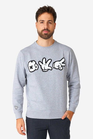 Man wearing grey sweater with chenille rock, paper, scissors embroidery