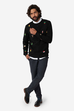 Man wearing black Christmas sweater with Christmas icons