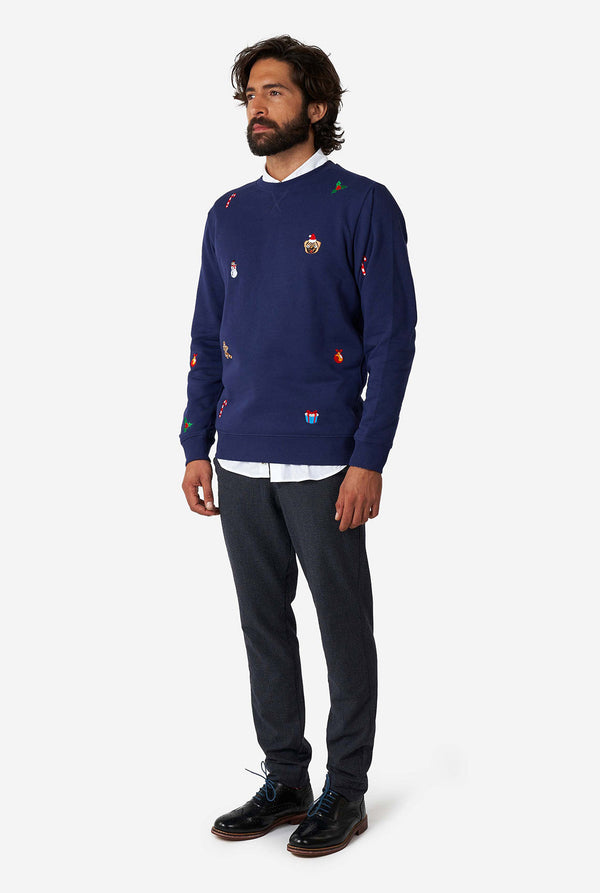 Man wearing blue Christmas sweater with Christmas icons