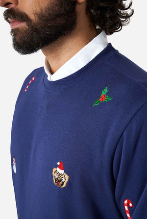 Man wearing blue Christmas sweater with Christmas icons
