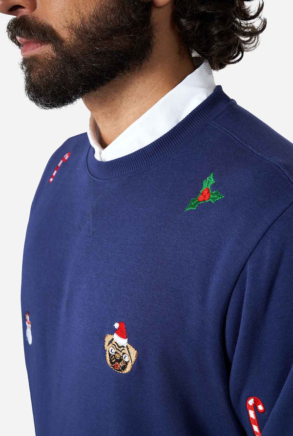 Man wearing blue Christmas sweater with Christmas icons