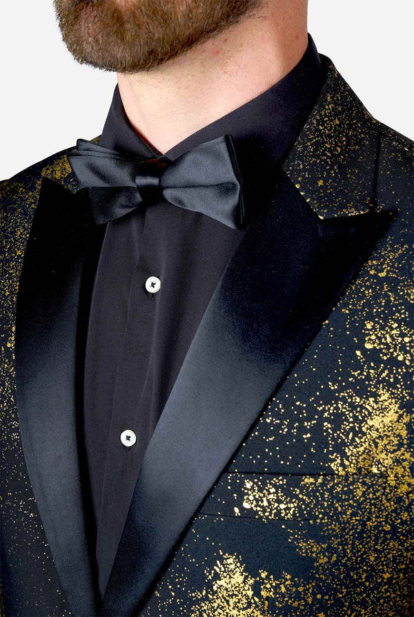 Man wearing black blazer with golden Christmas tree print