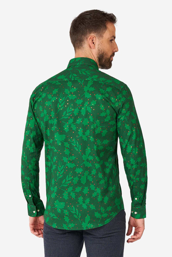 Man wearing green Christmas dress shirt with holly and mistletoe print