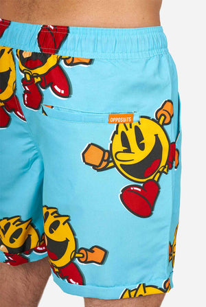 Man wearing blue summer shorts and shirt, with Pac-Man print