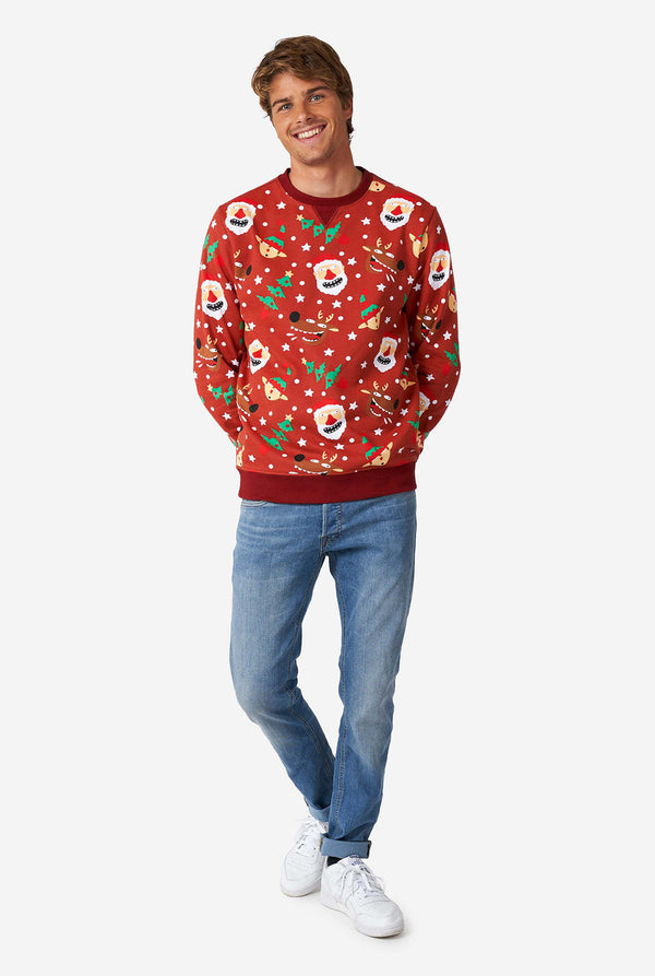 Man wearing red Christmas sweater with Christmas icons