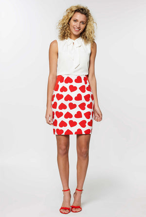 Woman wearing white Valentine's Day suit with red hearts
