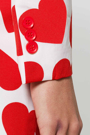 Woman wearing white Valentine's Day suit with red hearts