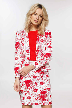 Woman wearing white suit with red blood spatters